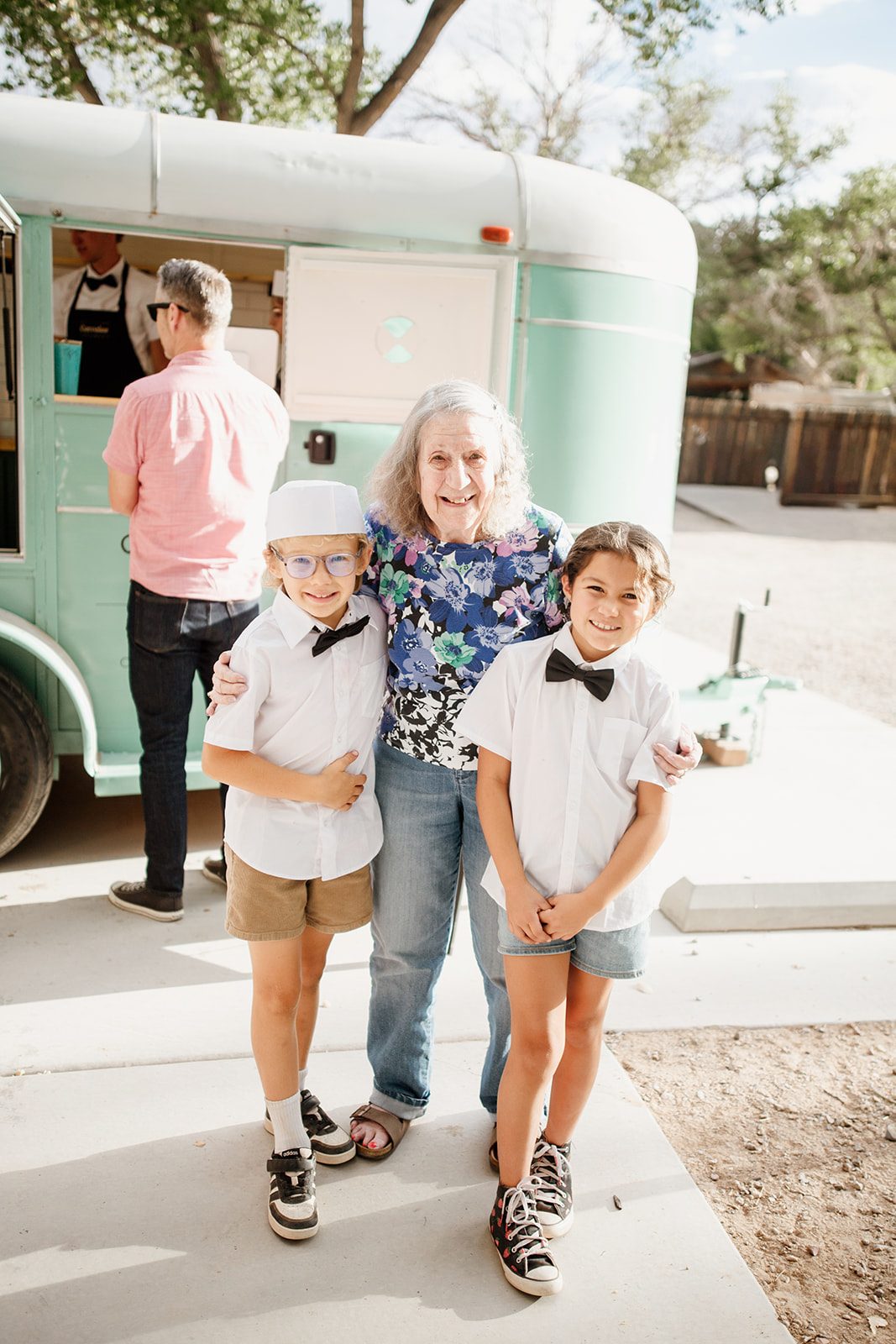 Three generations at the trailer — a grandmother with two of the young Corrales Creamery servers