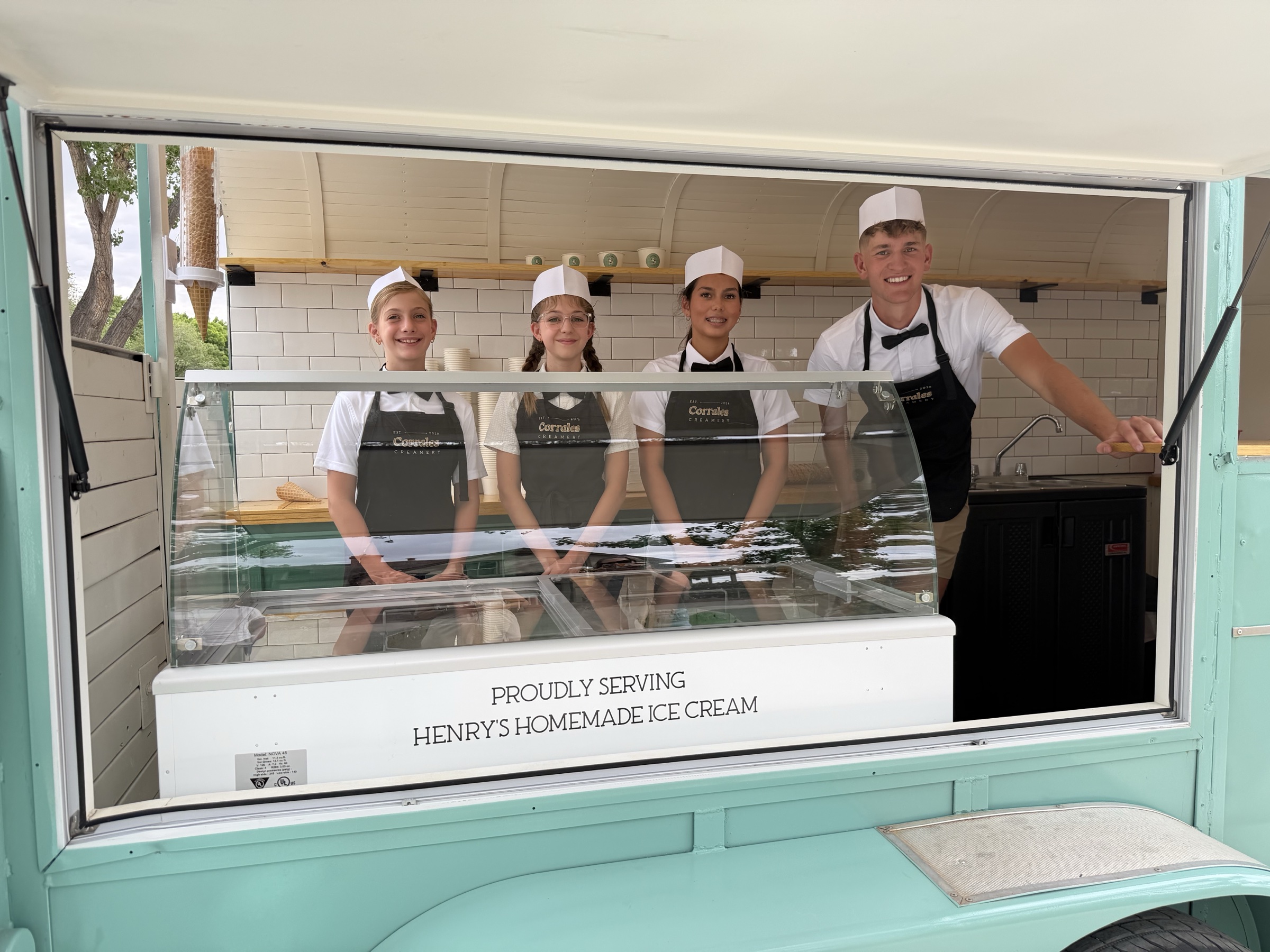The Corrales Creamery family serving from their vintage ice cream trailer